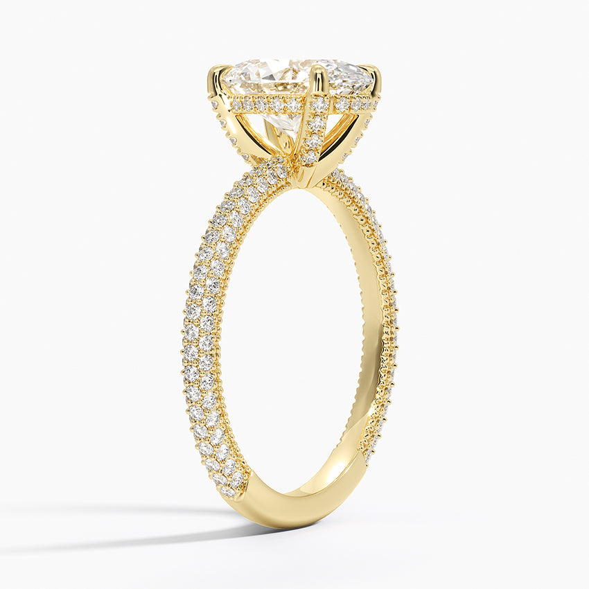 Oval diamond engagement ring with triple pavé band in yellow gold