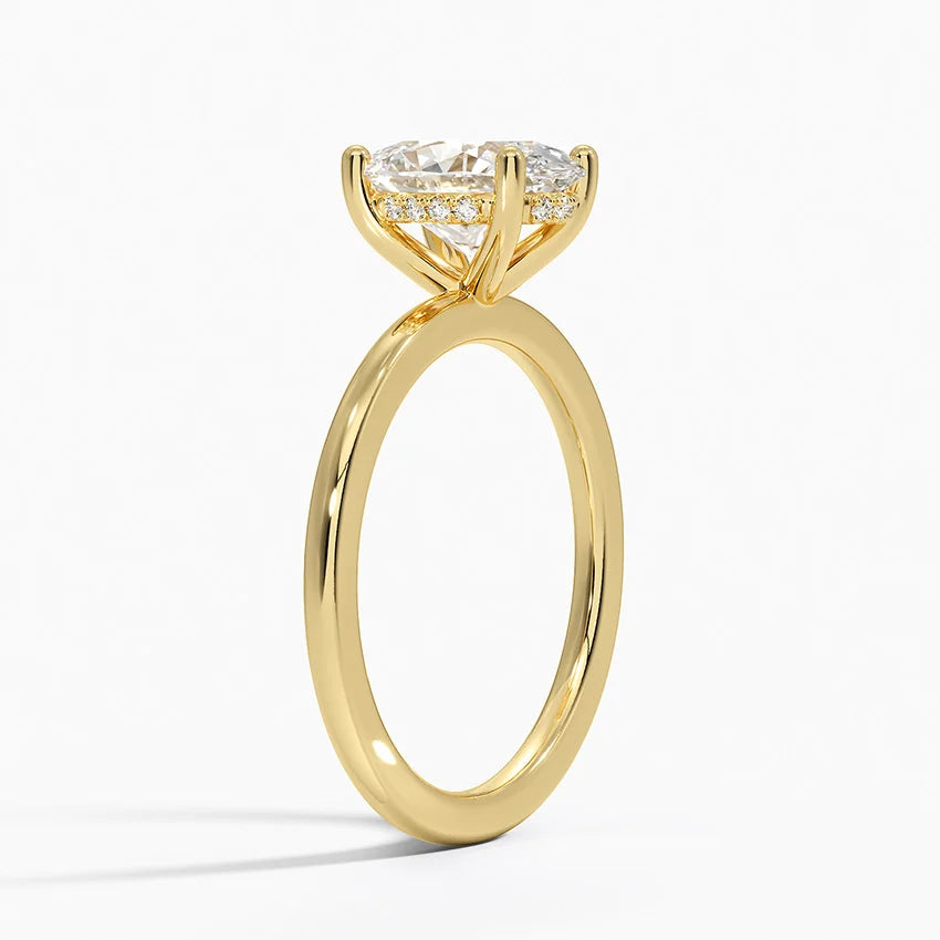 Oval hidden halo engagement ring in 18k yellow gold