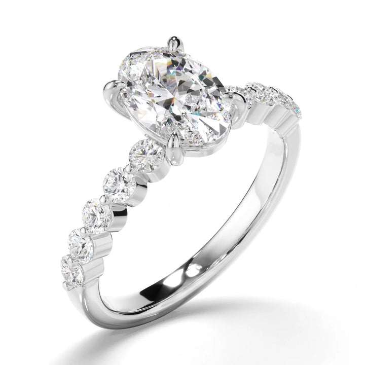 Oval engagement ring with round diamond accent band detail