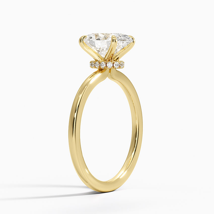 Oval hidden halo engagement ring in yellow metal